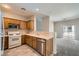 Kitchen features stainless steel appliances, wood cabinets, and access to the living room at 5915 Nuevo Leon St # 8, North Las Vegas, NV 89031