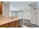 Kitchen leading to the living room, featuring stainless steel appliances and wooden cabinets at 5915 Nuevo Leon St # 8, North Las Vegas, NV 89031