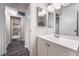 Bathroom with plank floors, white cabinets, and a view into the shower room at 6711 W Charleston Blvd # 2, Las Vegas, NV 89146