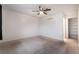 This bedroom offers neutral carpet, a ceiling fan, and a walk-in closet for storage at 6711 W Charleston Blvd # 2, Las Vegas, NV 89146