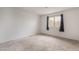 Bedroom featuring neutral carpet, black curtains, and a bright window at 6711 W Charleston Blvd # 2, Las Vegas, NV 89146