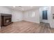 Bright living room featuring a brick fireplace and wood flooring at 6711 W Charleston Blvd # 2, Las Vegas, NV 89146