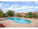 Community pool surrounded by mature trees in a condominium neighborhood at 6711 W Charleston Blvd # 2, Las Vegas, NV 89146