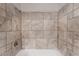Close up on the shower featuring tile surround and chrome shower head at 6711 W Charleston Blvd # 2, Las Vegas, NV 89146