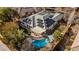 Aerial view of home with solar panels and a backyard oasis featuring a pool, patio, and lush landscaping at 6907 May Basket Ave, Las Vegas, NV 89131