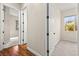 Neutral hallway with wood floors and carpeted rooms, offering a bright and airy transition between spaces at 6907 May Basket Ave, Las Vegas, NV 89131