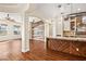 Kitchen with island and bar seating flows into the dining area with an accent wall at 6907 May Basket Ave, Las Vegas, NV 89131