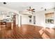 Open-concept living room with hardwood floors, with views to kitchen and patio at 6907 May Basket Ave, Las Vegas, NV 89131