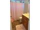 Bathroom features tile flooring, single sink vanity, and a shower/tub with a pink shower curtain at 7020 Puetollano Dr, North Las Vegas, NV 89084