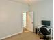 Bedroom features carpet flooring and a desk, providing a functional space for work or study at 7020 Puetollano Dr, North Las Vegas, NV 89084