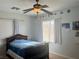 Comfortable bedroom with ceiling fan, window with blinds and curtains, and a visible planetary theme at 7020 Puetollano Dr, North Las Vegas, NV 89084