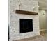 Elegant fireplace featuring a decorative stone surround and wooden mantle at 7020 Puetollano Dr, North Las Vegas, NV 89084