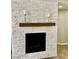 Stacked stone fireplace with rustic wood mantel, adding warmth and texture at 7020 Puetollano Dr, North Las Vegas, NV 89084