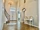 Grand foyer featuring tile flooring, staircase, chandelier, and a decorative console table at 7020 Puetollano Dr, North Las Vegas, NV 89084