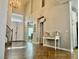 Grand foyer featuring tile flooring, staircase, chandelier, and a decorative console table at 7020 Puetollano Dr, North Las Vegas, NV 89084