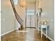 Grand foyer with tile flooring, staircase, chandelier, and a console table at 7020 Puetollano Dr, North Las Vegas, NV 89084