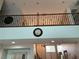 A wrought iron banister overlooks the living room at 7020 Puetollano Dr, North Las Vegas, NV 89084