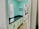 Bright kitchen featuring white cabinets, stainless steel appliances, black countertops, and a large island at 7020 Puetollano Dr, North Las Vegas, NV 89084