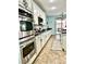 Bright kitchen features white cabinets, stainless steel appliances, and granite countertops at 7020 Puetollano Dr, North Las Vegas, NV 89084