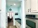 Bright kitchen featuring white cabinets, stainless steel appliances, black countertops, and a large island at 7020 Puetollano Dr, North Las Vegas, NV 89084