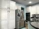 Bright kitchen featuring white cabinets, stainless steel appliances, black countertops, and a large island at 7020 Puetollano Dr, North Las Vegas, NV 89084