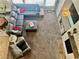 Open living room featuring a large sectional sofa, a fireplace, and carpet flooring at 7020 Puetollano Dr, North Las Vegas, NV 89084