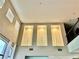 Living room features a high ceiling with wall decor at 7020 Puetollano Dr, North Las Vegas, NV 89084