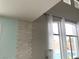 High ceiling with stacked stone wall detail and a view of the backyard pool at 7020 Puetollano Dr, North Las Vegas, NV 89084