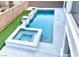 Backyard pool and spa featuring artificial grass, and modern landscaping at 7020 Puetollano Dr, North Las Vegas, NV 89084