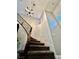 Curved carpeted staircase with iron spindles, featuring a decorative chandelier and light-colored walls at 7020 Puetollano Dr, North Las Vegas, NV 89084