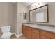 Bathroom with granite vanity, updated fixtures, and neutral color palette at 7200 Pirates Cove Rd # 1011, Las Vegas, NV 89145