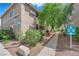 Exterior view of condo building 2 featuring a directional sign and desert landscaping at 7200 Pirates Cove Rd # 1011, Las Vegas, NV 89145