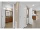 Hallway view showing bathroom, laundry, and kitchen access with wood-style flooring at 7200 Pirates Cove Rd # 1011, Las Vegas, NV 89145