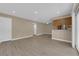 Bright living space with wood-look flooring with a view of the kitchen and the outdoor balcony at 7200 Pirates Cove Rd # 1011, Las Vegas, NV 89145