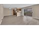 Open living space with wood-look flooring, ceiling fan, and view of kitchen and outdoor balcony at 7200 Pirates Cove Rd # 1011, Las Vegas, NV 89145