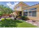 Expansive backyard featuring lush green grass, mature trees, and a covered patio at 7417 Horizon Rock Ave, Las Vegas, NV 89179