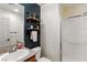 Stylish bathroom featuring a shower, modern fixtures, and open shelving for storage at 7417 Horizon Rock Ave, Las Vegas, NV 89179