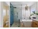 Bright bathroom with soaking tub, glass shower and wooden vanity cabinets at 7417 Horizon Rock Ave, Las Vegas, NV 89179