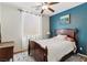 Cozy bedroom featuring a ceiling fan, plush bedding, and a soothing accent wall at 7417 Horizon Rock Ave, Las Vegas, NV 89179