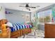 Bright bedroom with ceiling fan, window with blinds, and colorful decor at 7417 Horizon Rock Ave, Las Vegas, NV 89179