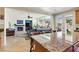 Bright, open kitchen with island seating overlooking the living room with fireplace and large windows at 7417 Horizon Rock Ave, Las Vegas, NV 89179