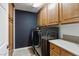 Well-equipped laundry room with modern washer and dryer units and ample cabinet space at 7417 Horizon Rock Ave, Las Vegas, NV 89179