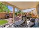 Inviting covered patio with comfortable seating and a view of the landscaped backyard at 7417 Horizon Rock Ave, Las Vegas, NV 89179