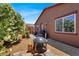 Private backyard featuring decorative gravel, a fire pit, and mature landscaping at 7428 Alamo Ranch Ave, Las Vegas, NV 89179