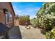 Landscaped backyard featuring decorative gravel, a fire pit, and mature landscaping at 7428 Alamo Ranch Ave, Las Vegas, NV 89179
