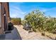 Patio featuring decorative gravel, tiled pathways, and mature landscaping, with grills at 7428 Alamo Ranch Ave, Las Vegas, NV 89179