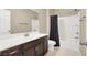 Bathroom featuring a vanity with dark wood cabinets, shower, and a toilet with a dark curtain at 7428 Alamo Ranch Ave, Las Vegas, NV 89179