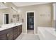Elegant bathroom featuring a dual sink vanity, soaking tub, and a separate shower area, offering a spa-like experience at 7428 Alamo Ranch Ave, Las Vegas, NV 89179