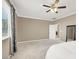 Bright bedroom featuring neutral walls, carpet floors, ceiling fan, and ensuite access, creating a cozy atmosphere at 7428 Alamo Ranch Ave, Las Vegas, NV 89179
