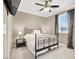 Comfortable bedroom features a metal frame bed, ceiling fan, and a window with natural light at 7428 Alamo Ranch Ave, Las Vegas, NV 89179